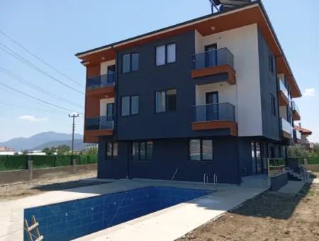 1 1 Wohnung Zu Verkaufen Mit Pool In Ortaca Karaburun Nachbarschaft